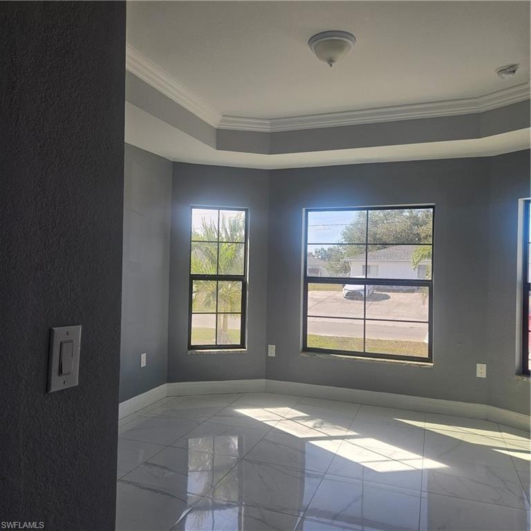 131 Gilbert Avenue South Lehigh Acres, FL 33973 - Photo 9 of 13 a spacious bedroom with a bed and a window