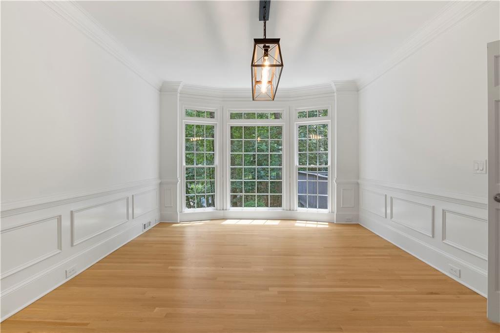 8965 Laurel Way Alpharetta, GA 30022 - Photo 17 of 79 a view of an empty room with wooden floor and a window