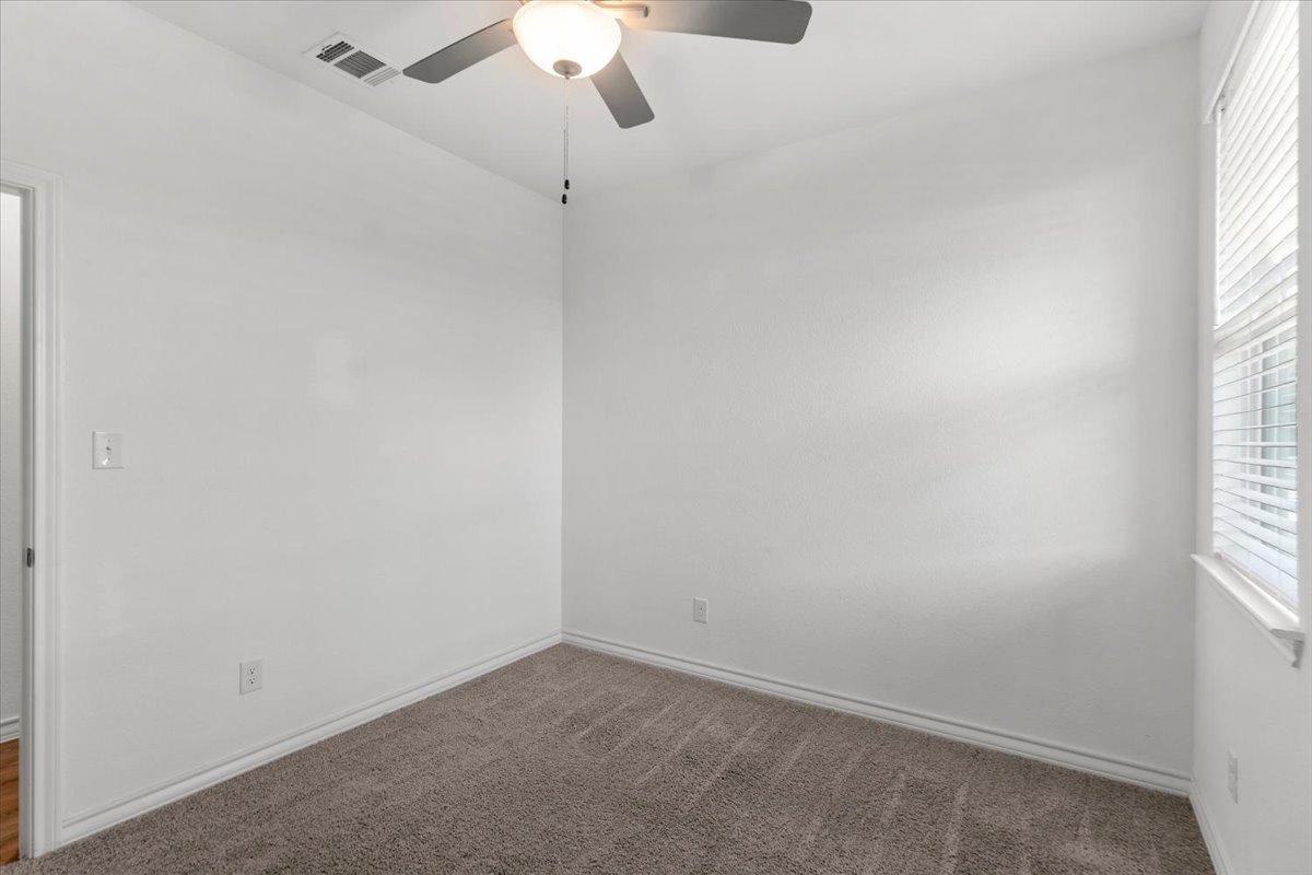 500 Stinchcomb Road Hutto, TX 78634 - Photo 26 of 37 A well-proportioned room featuring a ceiling fan and ample natural light from a generous window.