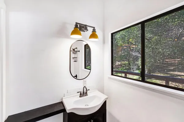 a bathroom with a sink a mirror and a window