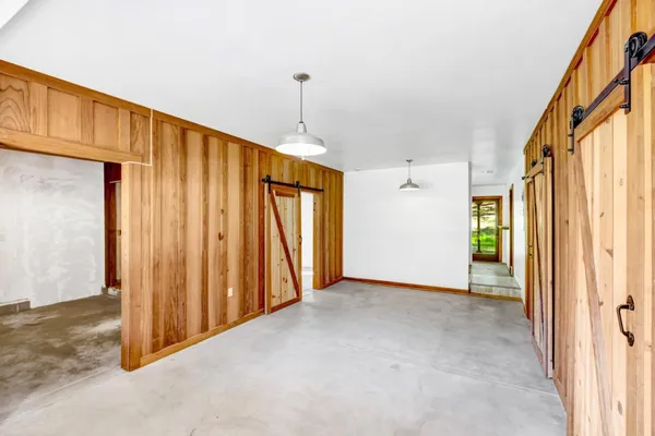 a view of a hallway with wooden walls