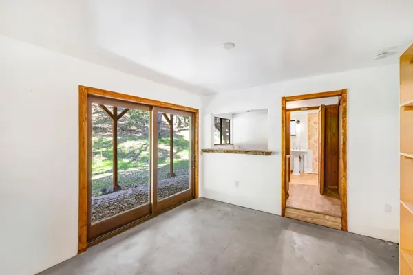 a view of empty room with floor to ceiling window