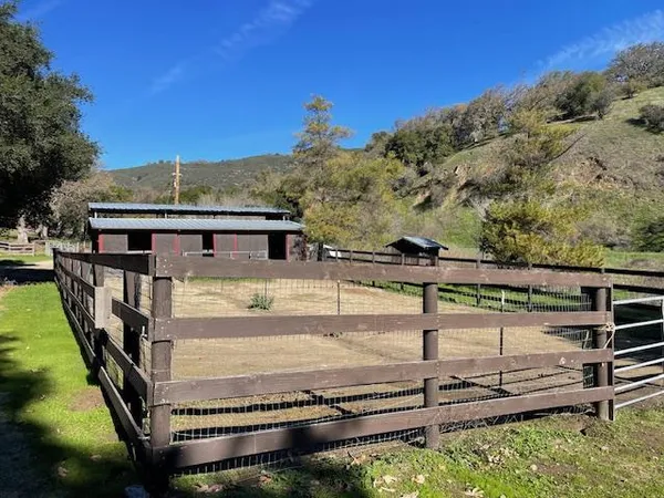 a view of a house with backyard of house and sitting area