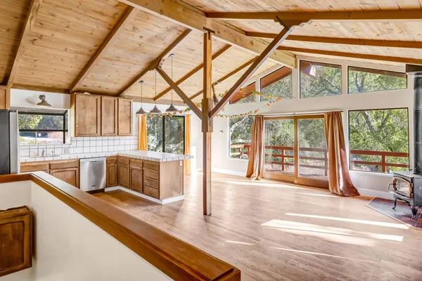 a view of a kitchen with stainless steel appliances granite countertop a sink and cabinets