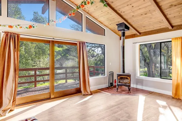 a view of a room with a large window and sitting area