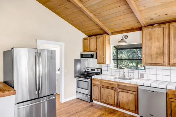 a kitchen with stainless steel appliances a refrigerator and a sink
