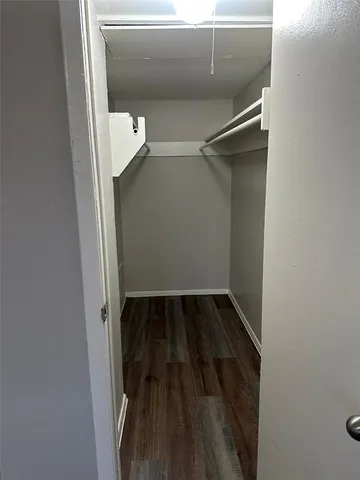 a view of walk in closet with empty racks