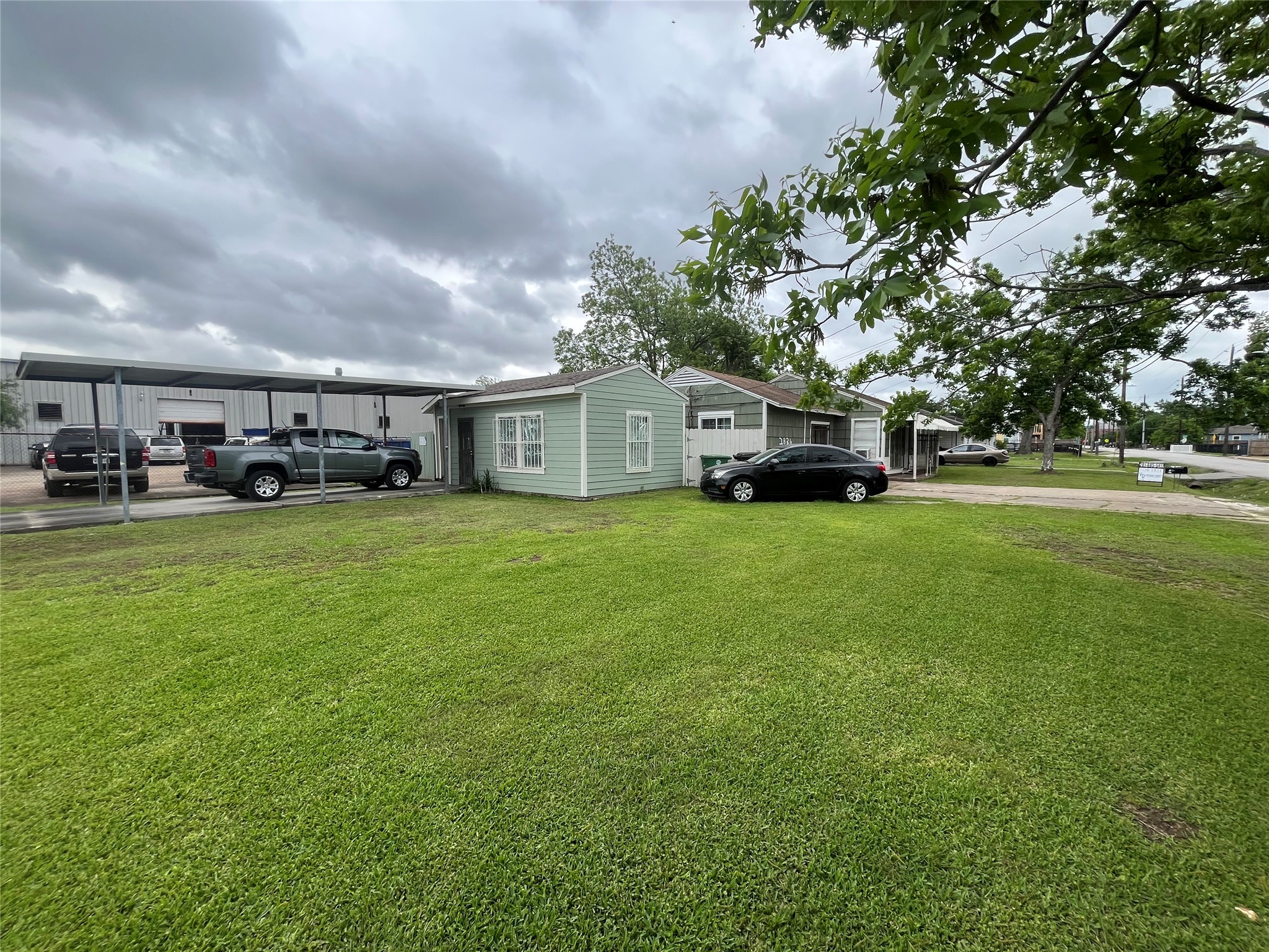2836 Cochran Street Houston, TX 77009 - Photo 1 of 17 a view of a house with a big yard and large trees