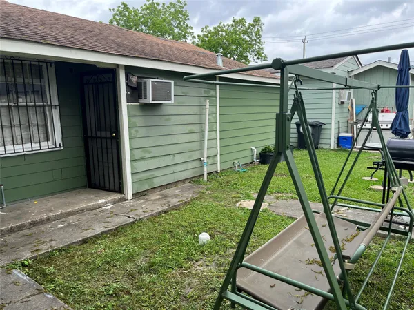 a backyard of a house with table and chairs