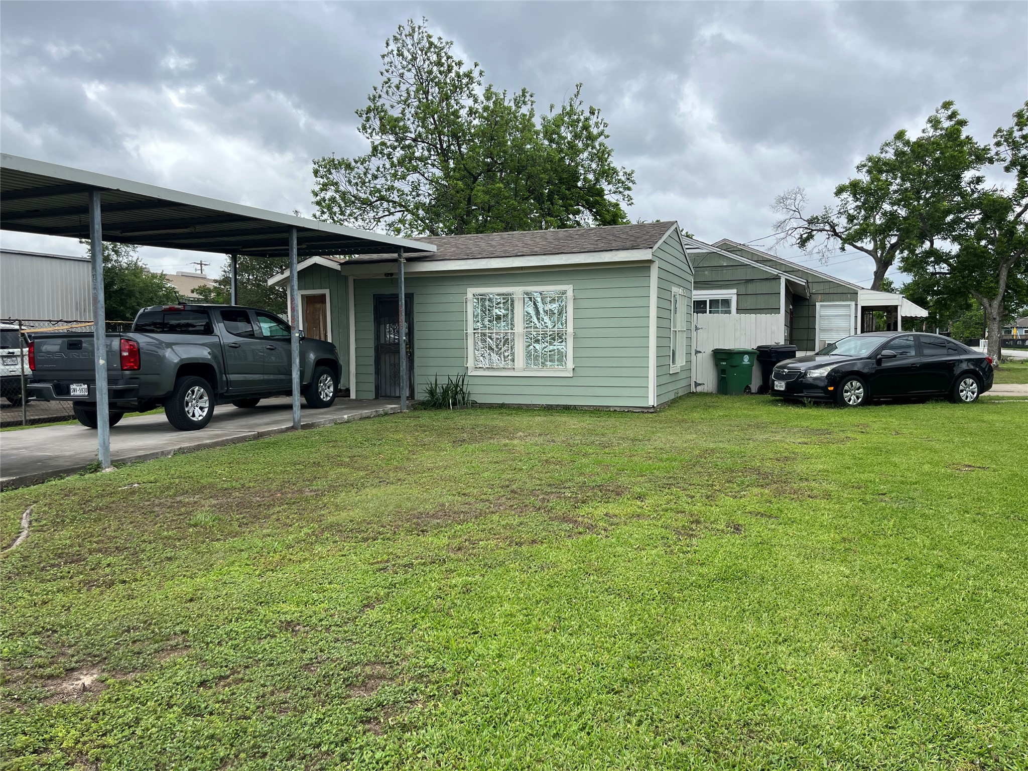 2836 Cochran Street Houston, TX 77009 - Photo 13 of 17 a view of a house with a yard and garage