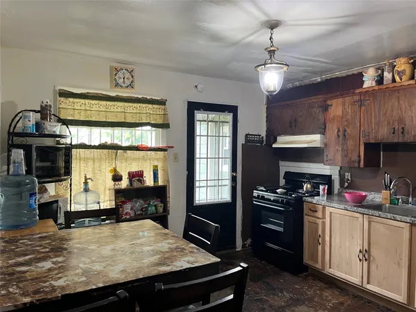a kitchen with granite countertop a stove and a refrigerator