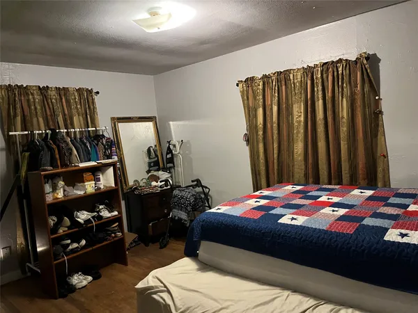 a bedroom with a bed a mirror and book shelf