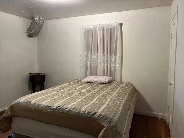 a bed sitting in a bedroom next to a window