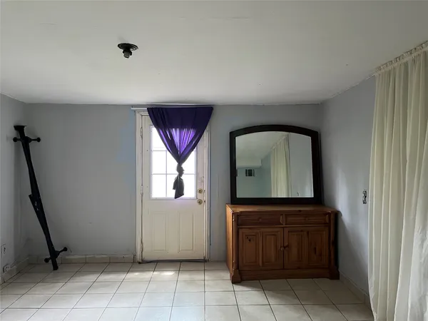a view of a hallway with front door and windows