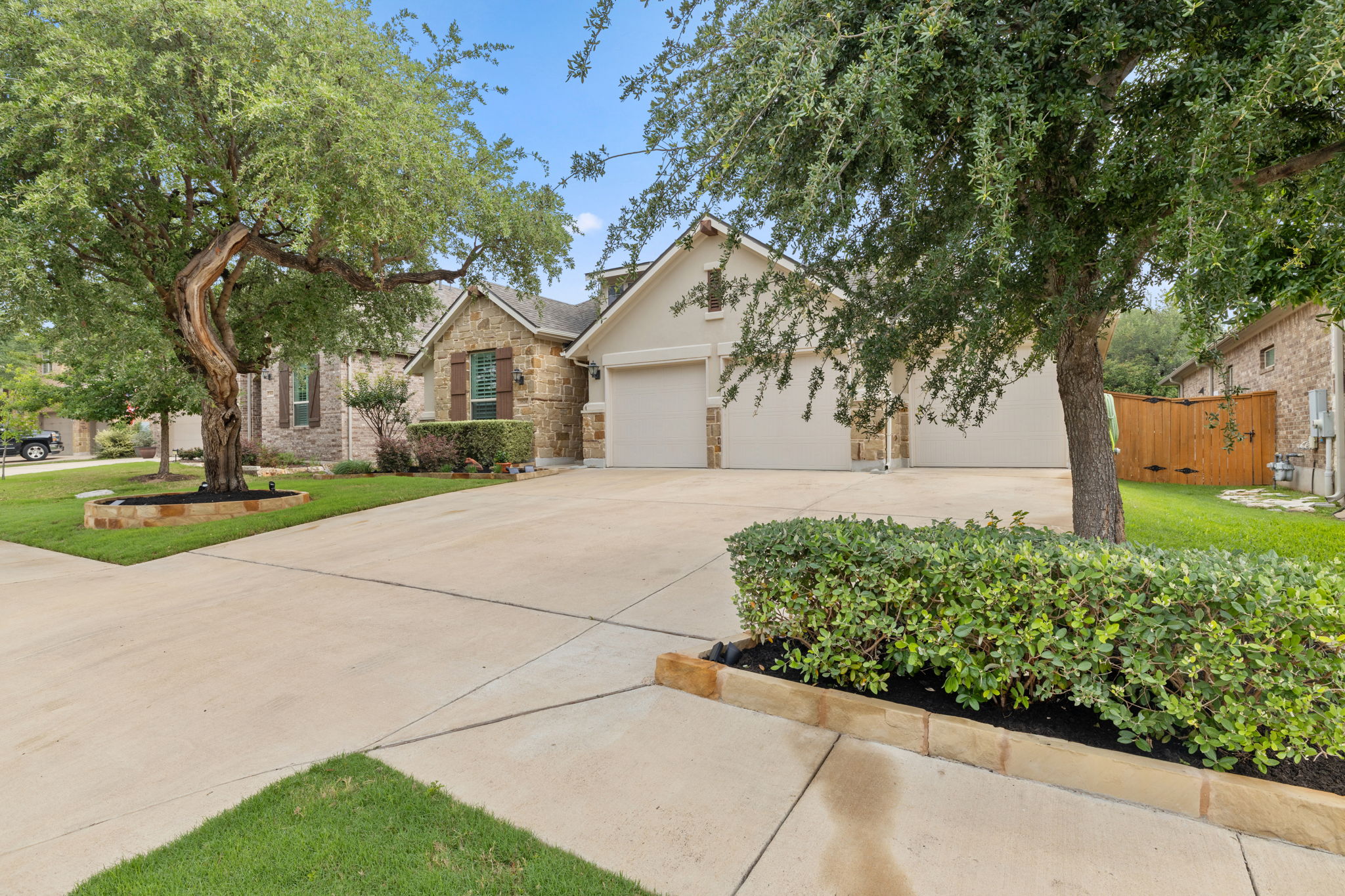 Beautiful trees and landscaping grace the front yard