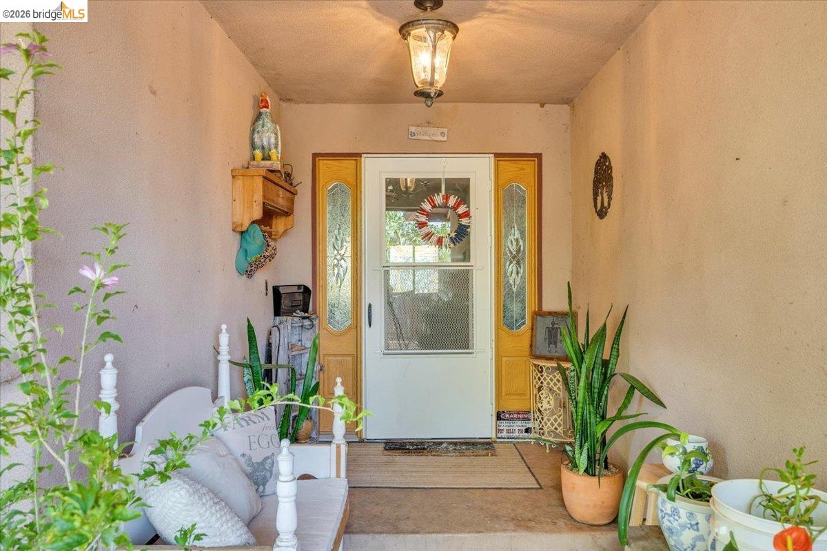14450 Jacksonville Road Jamestown, CA 95327 - Photo 13 of 85 Entryway featuring a white door with a clear glass insert, flanked by sidelight windows with decorative glass
