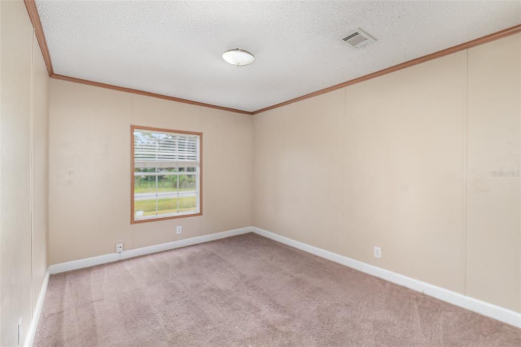 25542 Mathew Street Christmas, FL 32709 - Photo 11 of 18 an empty room with a window