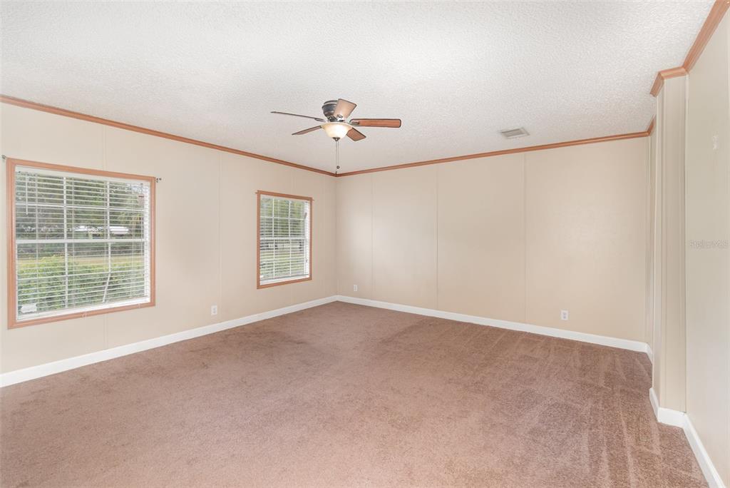 25542 Mathew Street Christmas, FL 32709 - Photo 13 of 18 an empty room with windows and ceiling fan