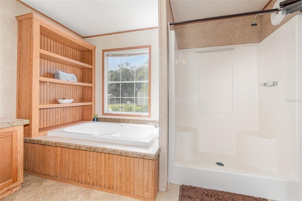 25542 Mathew Street Christmas, FL 32709 - Photo 15 of 18 a bathroom with a bathtub and a shower