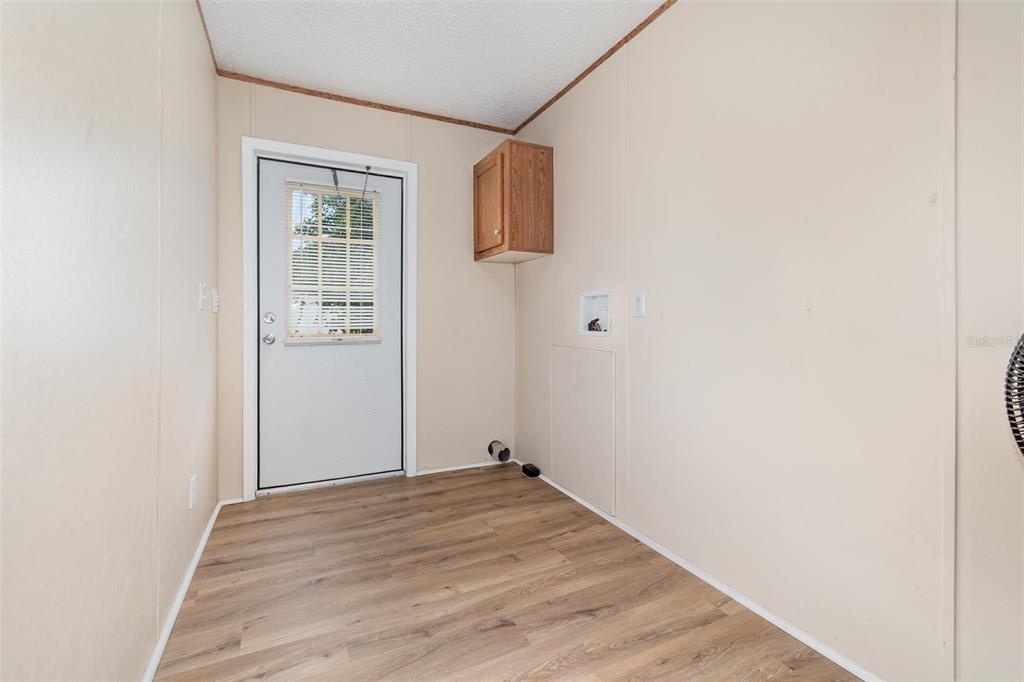 25542 Mathew Street Christmas, FL 32709 - Photo 16 of 18 a view of an empty room with wooden floor and a window
