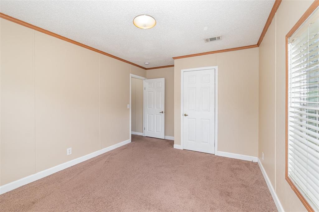25542 Mathew Street Christmas, FL 32709 - Photo 10 of 18 an empty room with windows and closet