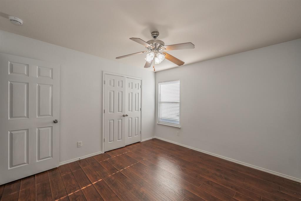 712 Grant Street Burleson, TX 76028 - Photo 22 of 28 a view of an empty room with a window and wooden floor