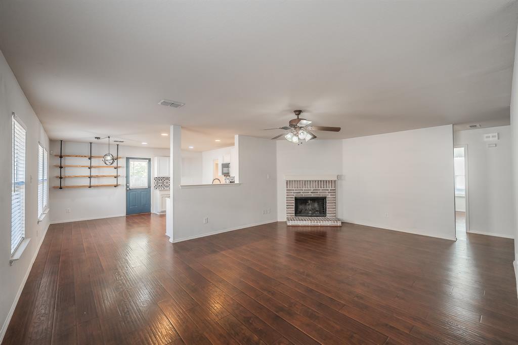 712 Grant Street Burleson, TX 76028 - Photo 3 of 28 a view of empty room with wooden floor and fireplace
