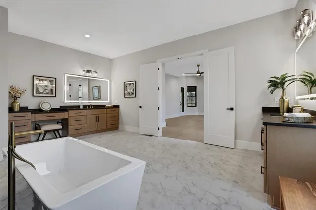a kitchen with stainless steel appliances granite countertop a stove a sink and a white cabinets