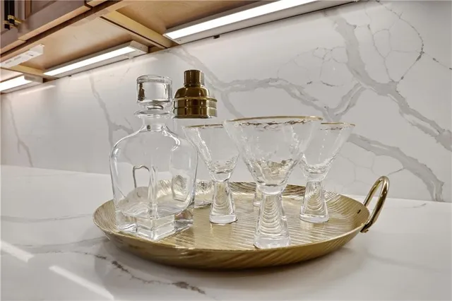 a view of a big house with a big yard and large trees