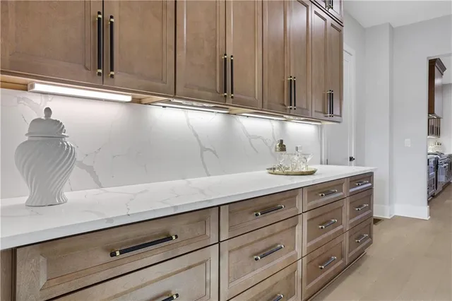 a front view of a house with a yard and large trees