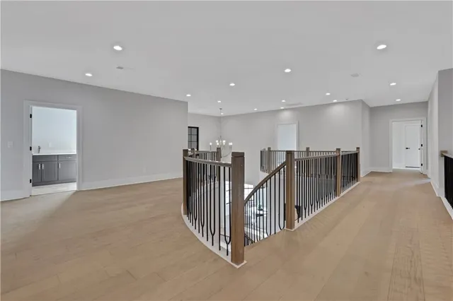 a front view of a house with a garden and trees