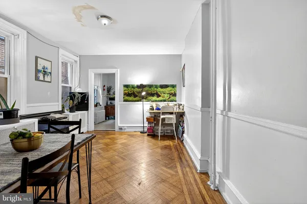 a living room with furniture a flat screen tv and floor to ceiling window