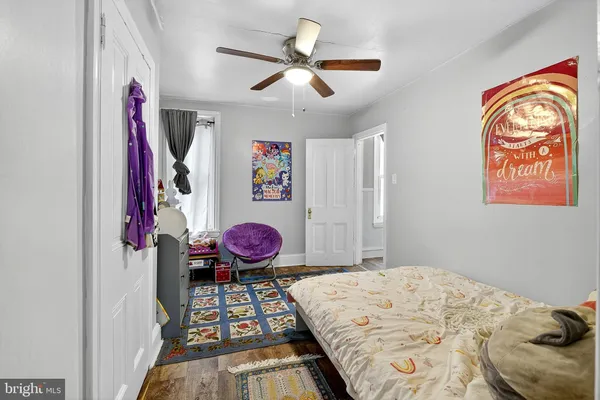 a bed room with a bed mirror and a window