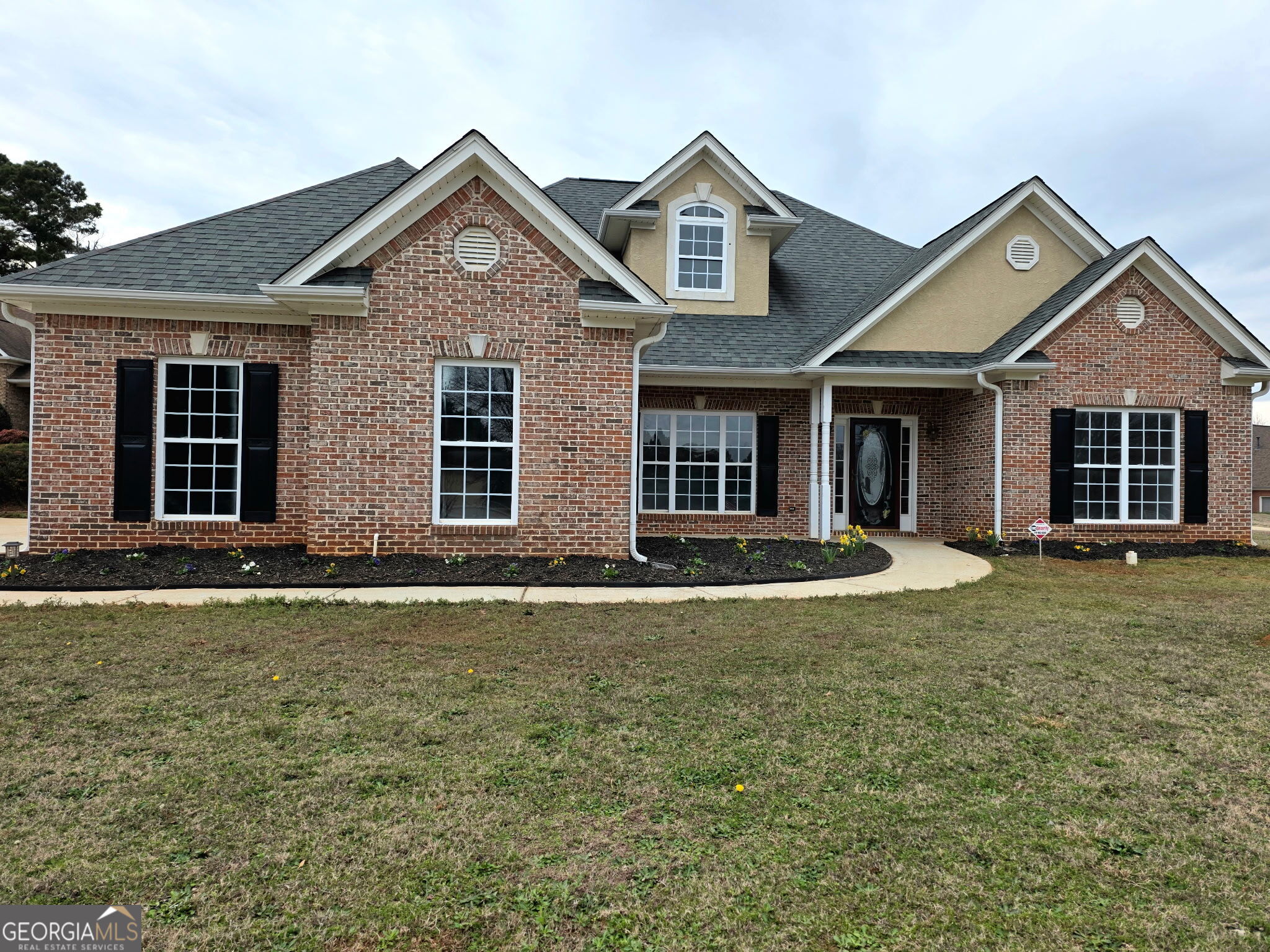 front view of a house with a yard