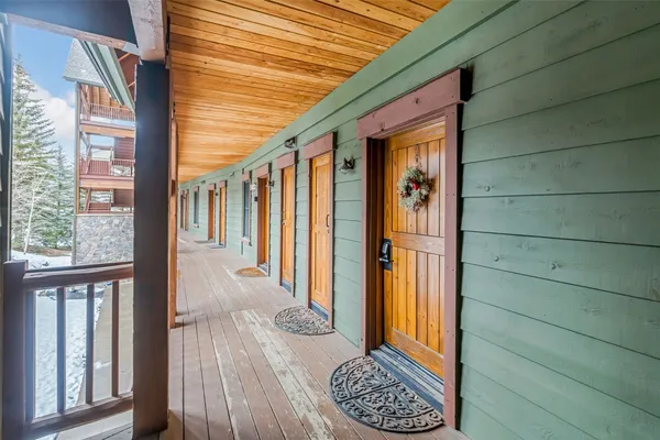 a living room with furniture large window and fireplace