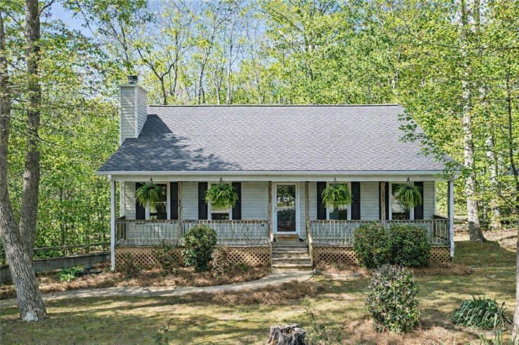 4865 Old Burnt Mountain Road Jasper, GA 30143 - Photo 1 of 1 a front view of a house with garden