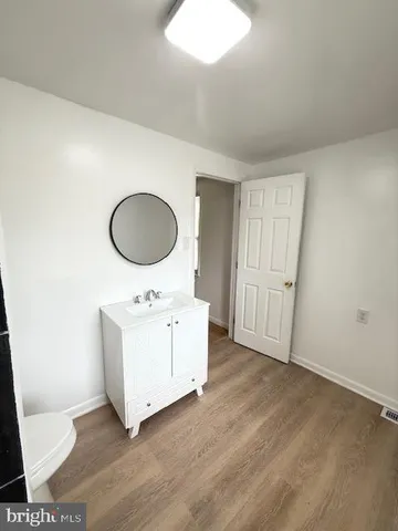 a room with wooden floor and white walls