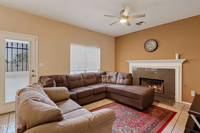 a living room with furniture and a fireplace