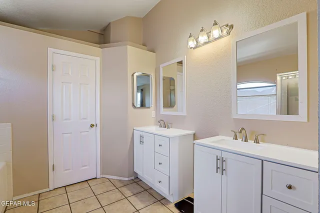 a spacious bathroom with a double vanity sink mirror and