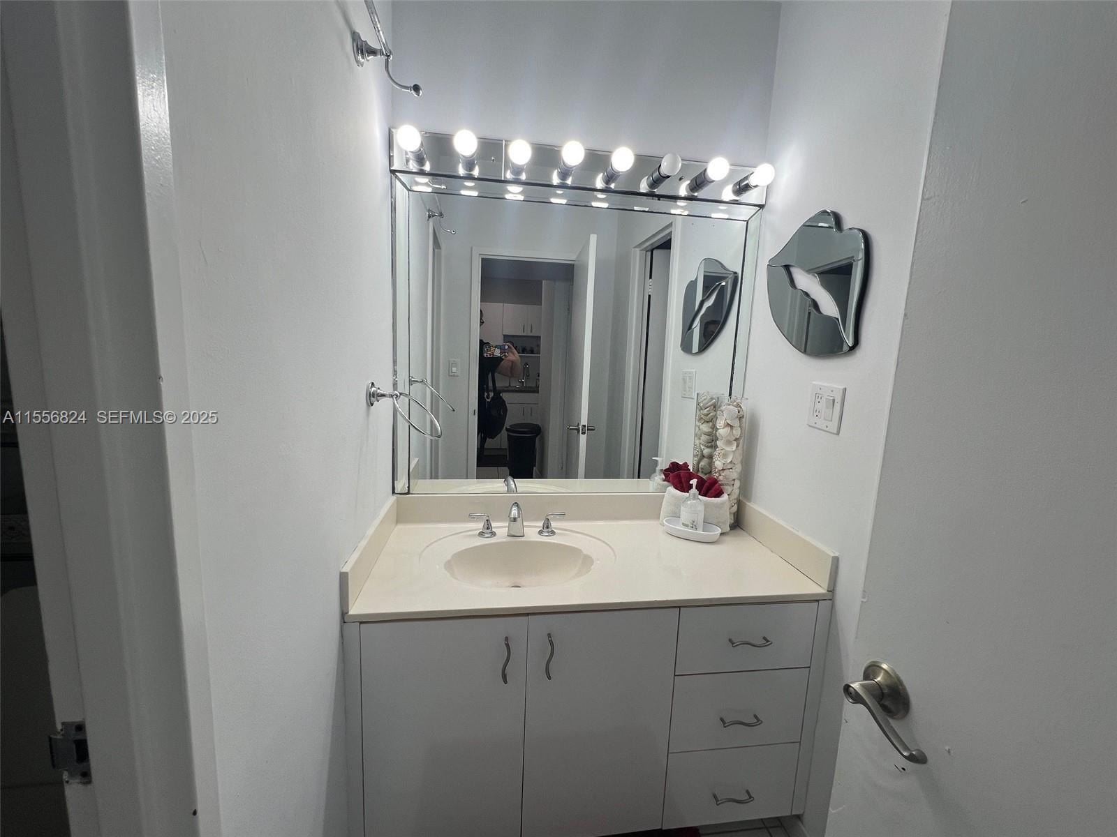 100 Lincoln Road, Unit 1126 Miami Beach, FL 33139 - Photo 11 of 52 a bathroom with a double vanity sink and a mirror