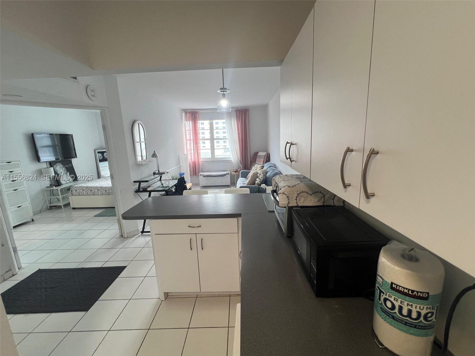 100 Lincoln Road, Unit 1126 Miami Beach, FL 33139 - Photo 14 of 52 a kitchen with a sink a stove and cabinets