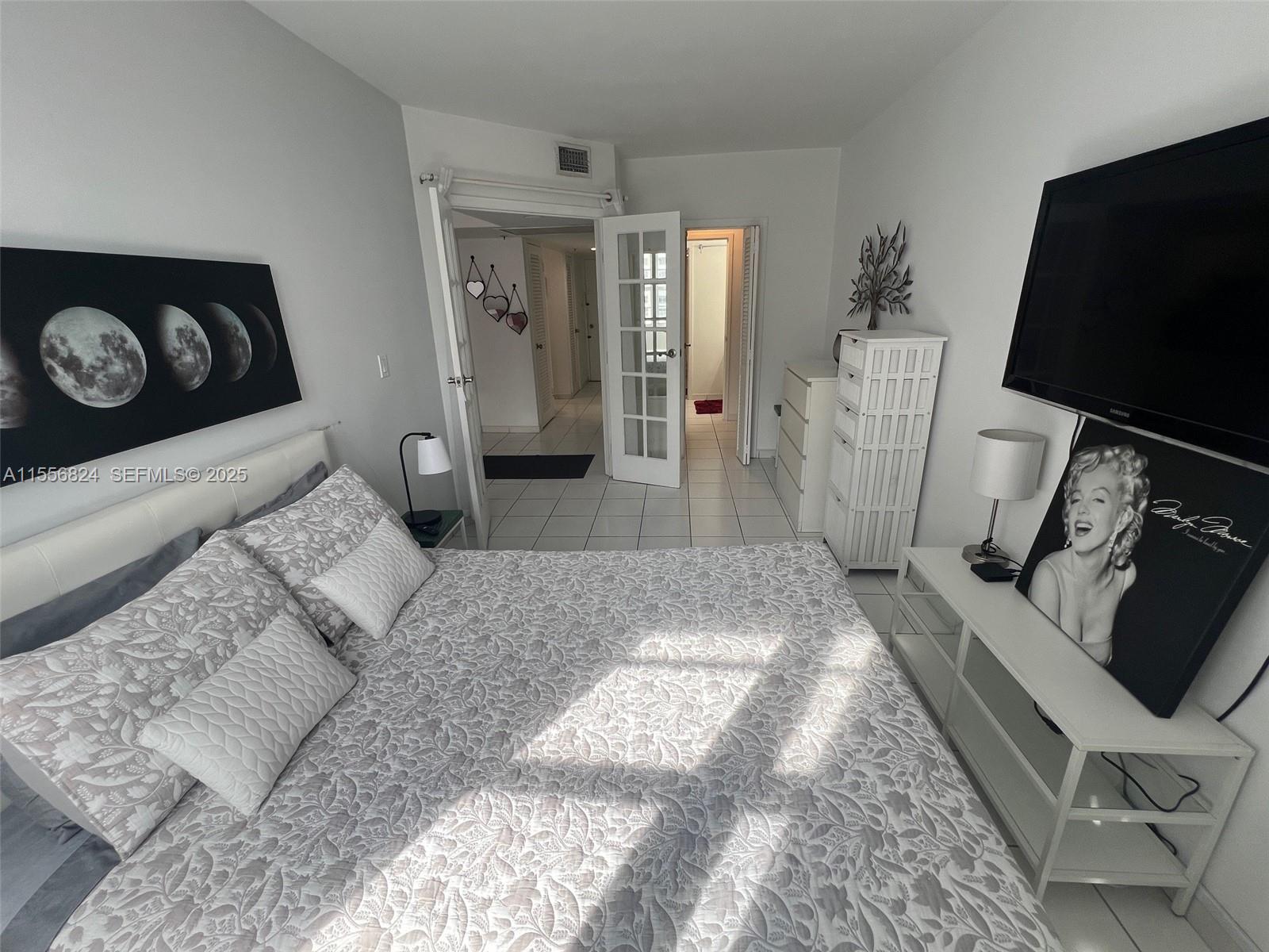 100 Lincoln Road, Unit 1126 Miami Beach, FL 33139 - Photo 6 of 52 a living room with furniture and a flat screen tv