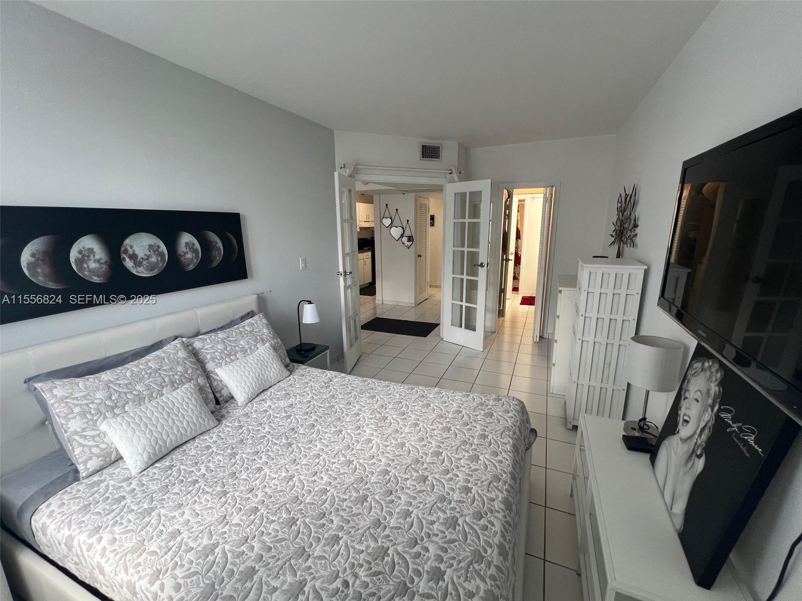 100 Lincoln Road, Unit 1126 Miami Beach, FL 33139 - Photo 7 of 52 a bedroom with a bed and wooden floor