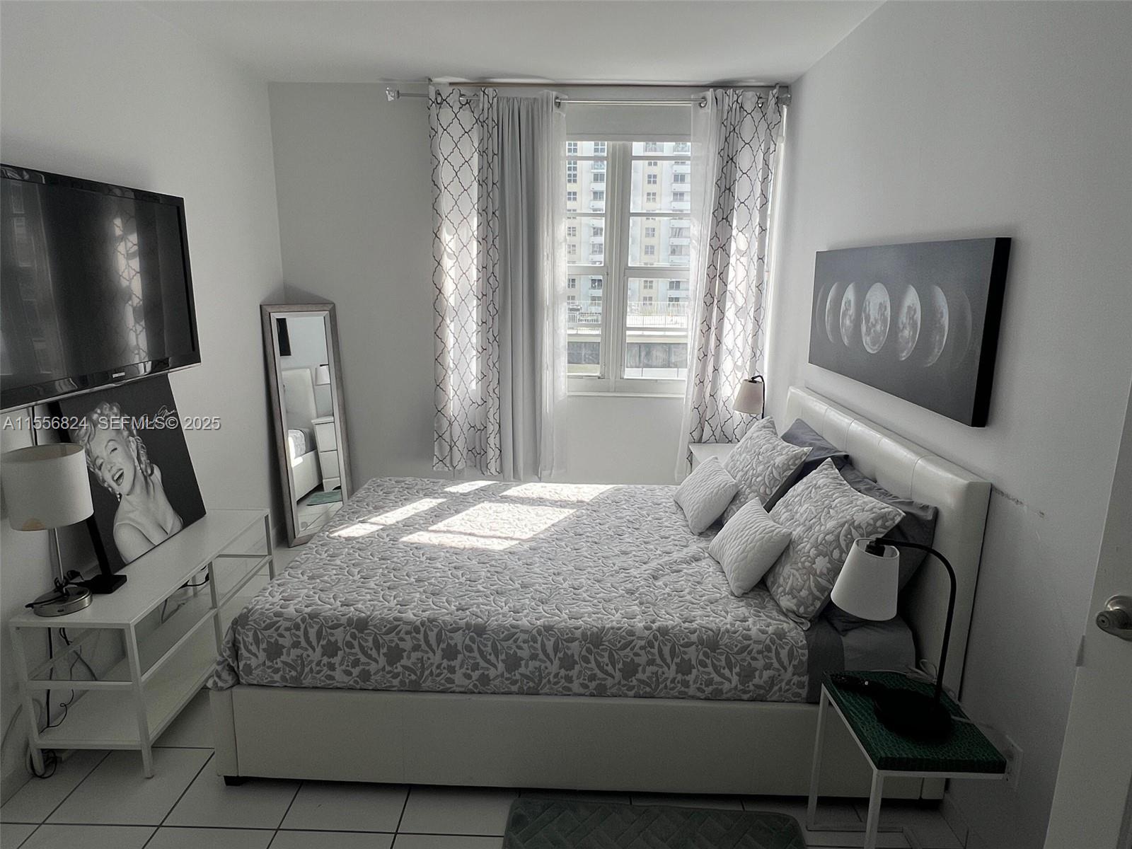 100 Lincoln Road, Unit 1126 Miami Beach, FL 33139 - Photo 8 of 52 a bedroom with a bed tv and dresser