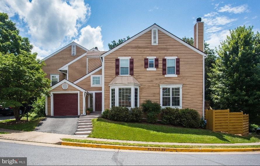 1511 Deer Point Way Reston, VA 20194 - Photo 1 of 30 a front view of a house with a yard and garage