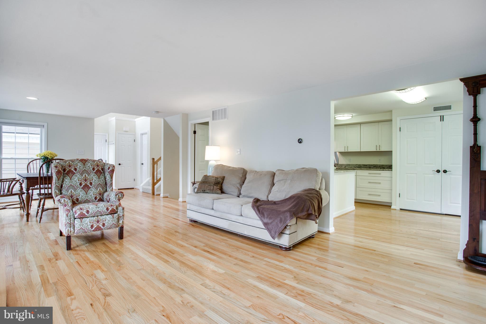 1511 Deer Point Way Reston, VA 20194 - Photo 14 of 30 a living room with furniture and a wooden floor
