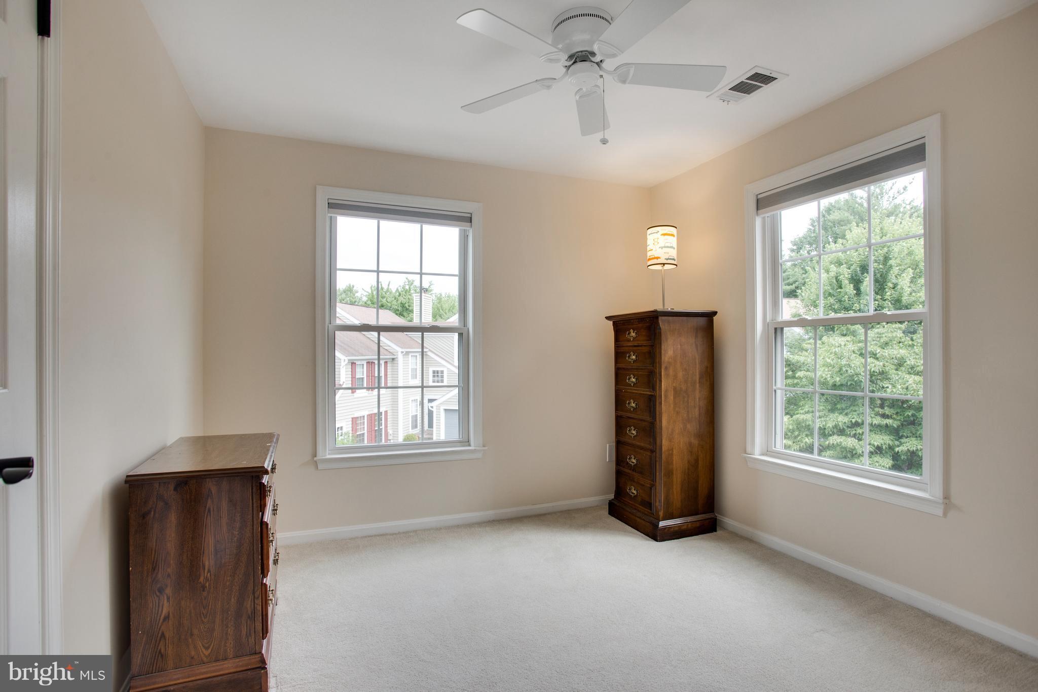 1511 Deer Point Way Reston, VA 20194 - Photo 18 of 30 a view of an empty room with a window and wooden floor