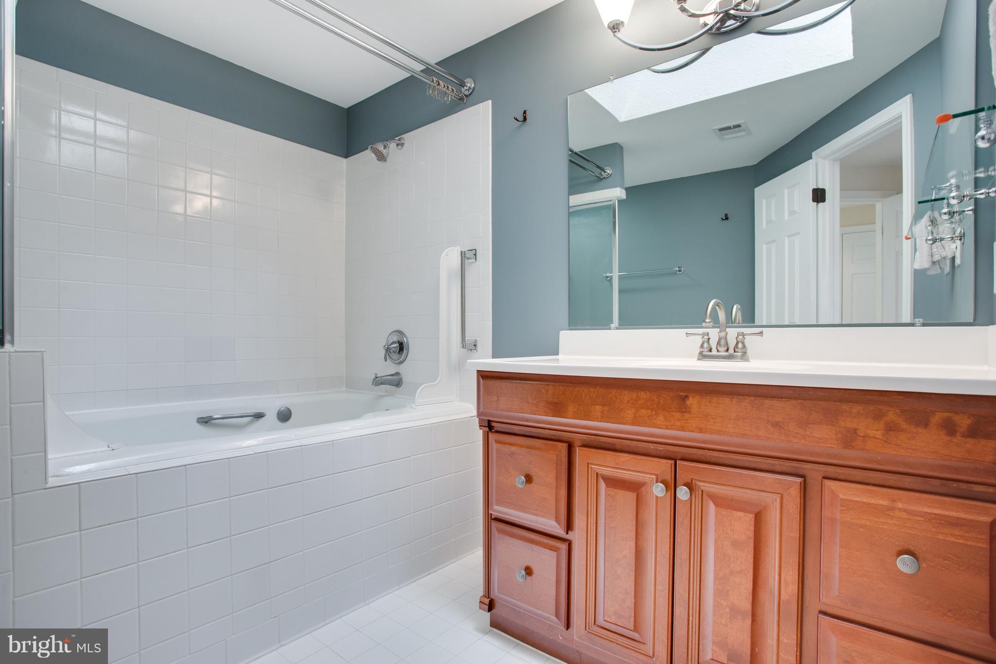 1511 Deer Point Way Reston, VA 20194 - Photo 21 of 30 a bathroom with a double vanity sink a mirror and a bathtub