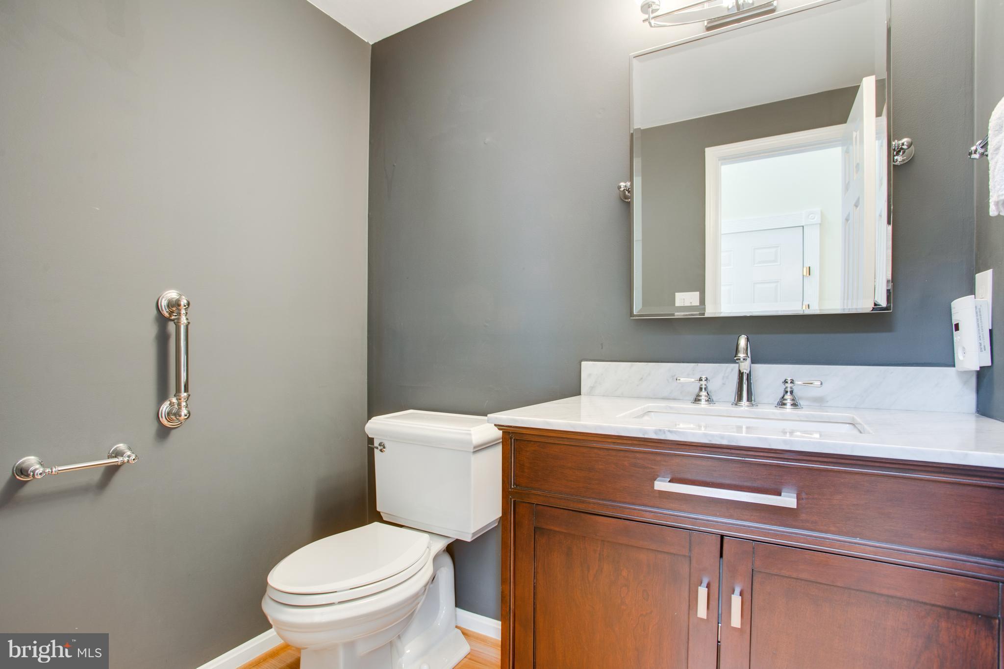 1511 Deer Point Way Reston, VA 20194 - Photo 23 of 30 a bathroom with a granite countertop toilet sink and mirror