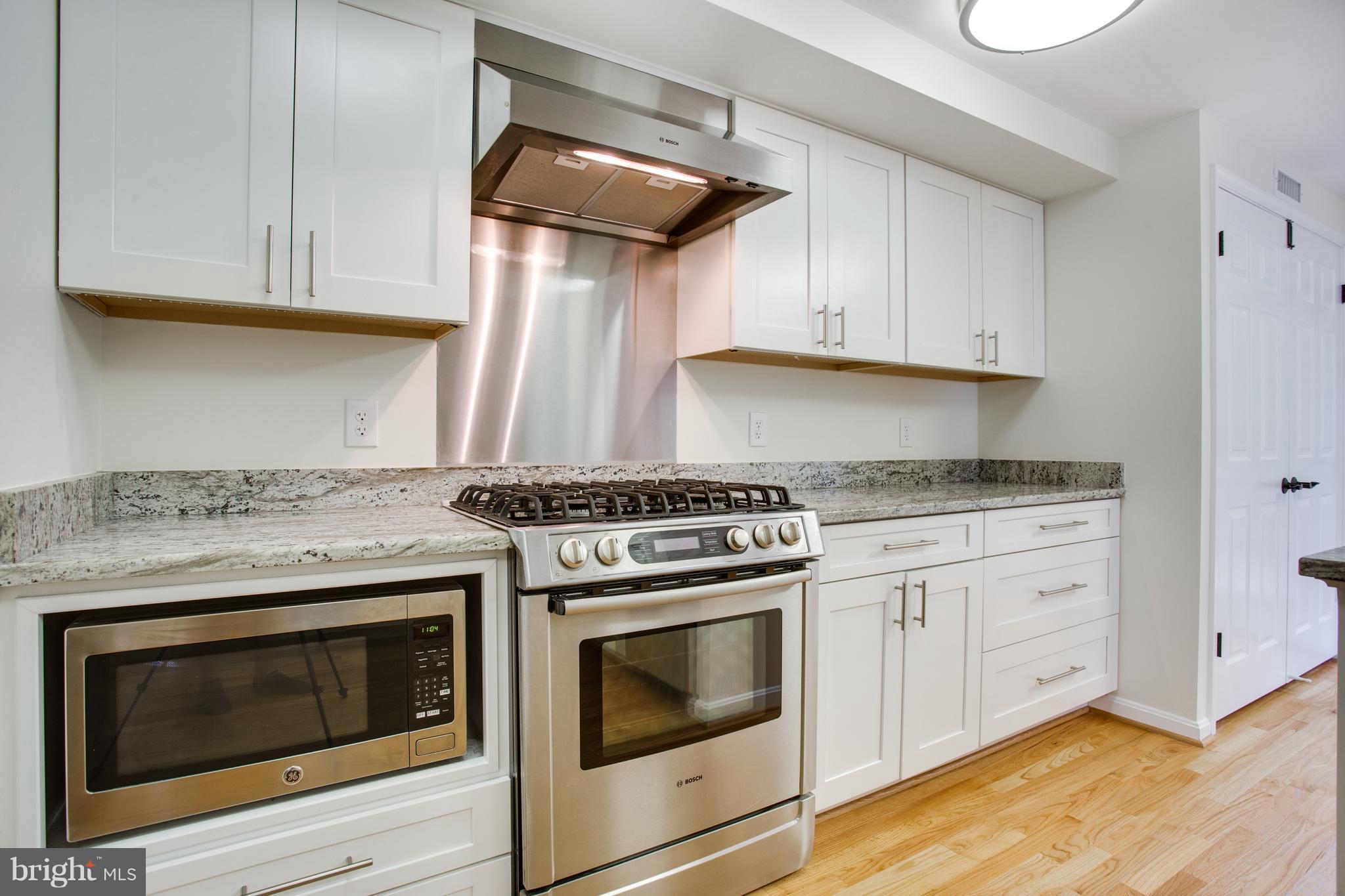1511 Deer Point Way Reston, VA 20194 - Photo 4 of 30 a kitchen with granite countertop cabinets stainless steel appliances and wooden floor